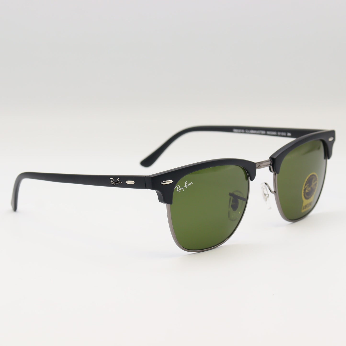 RayBan RB3016 Clubmaster sunglasses with black and tortoiseshell acetate frames, featuring classic design and tinted lenses.