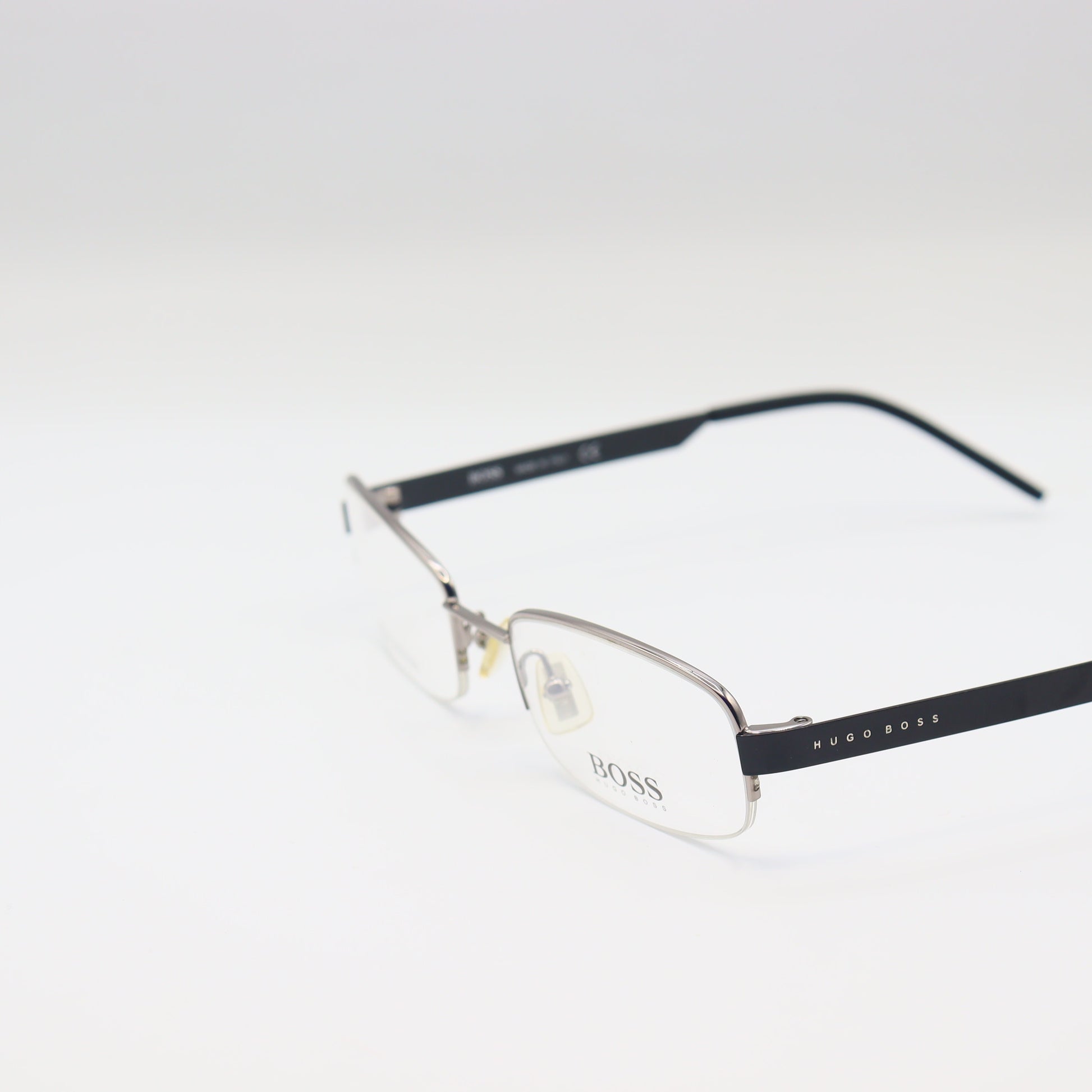 Chashmay Khas® rectangular Hugo Boss stainless steel eyeglasses with silver and black frames placed on a white background.