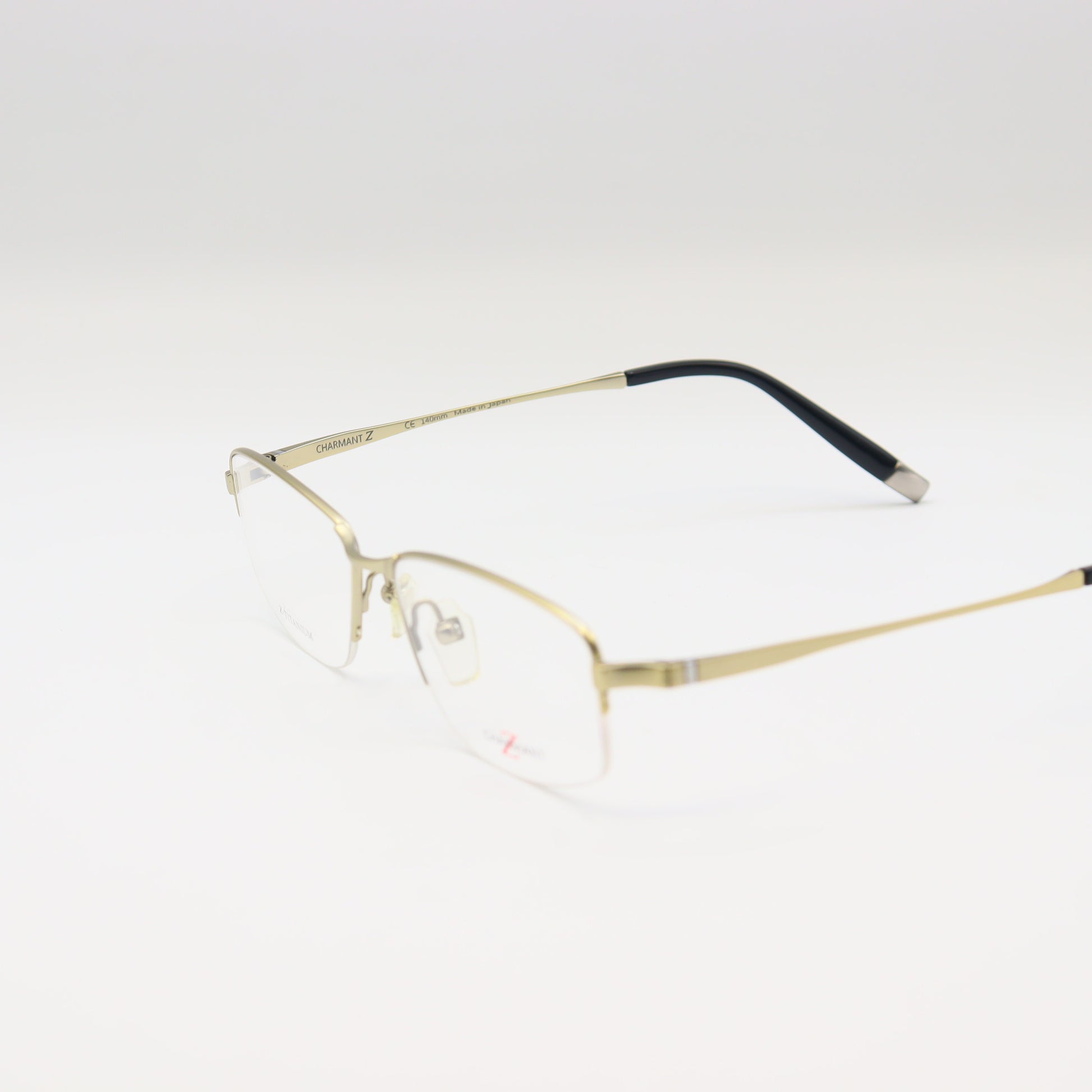 Gold lightweight rectangular Z-Titanium eyeglasses by CHASHMAY KHAS® featuring sleek metal frames and clear lenses.