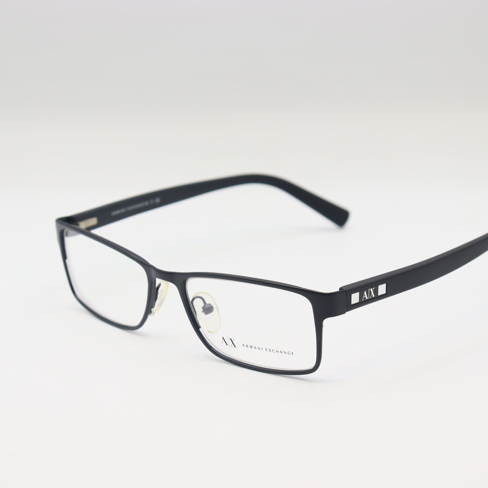 Black Armani Exchange rectangular eyeglasses with matte frame, stylish CHASHMAY KHAS® spectacles, close-up view of the frames.