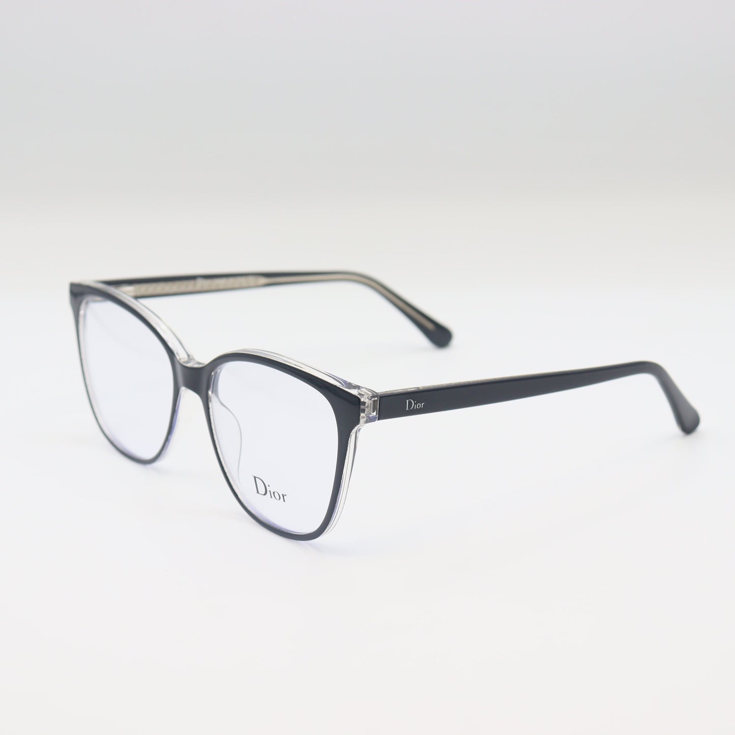 Black Dior cat-eye spectacles with silver trim, luxury eyewear by CHASHMAY KHAS® featuring a sleek, stylish design.