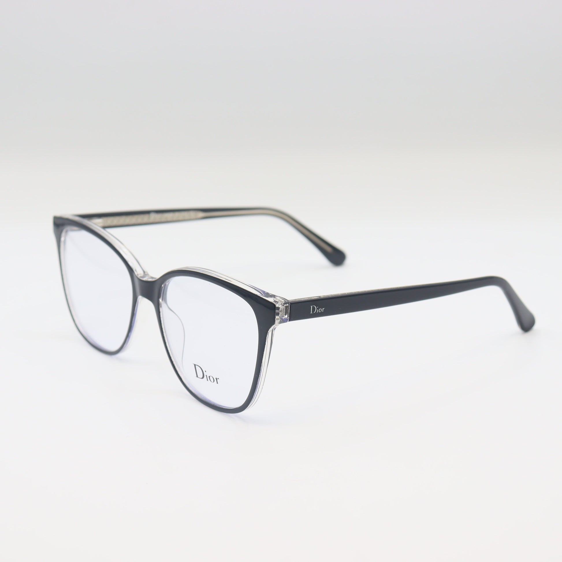 Black Dior cat-eye spectacles with silver trim, luxury eyewear by CHASHMAY KHAS® featuring a sleek, stylish design.