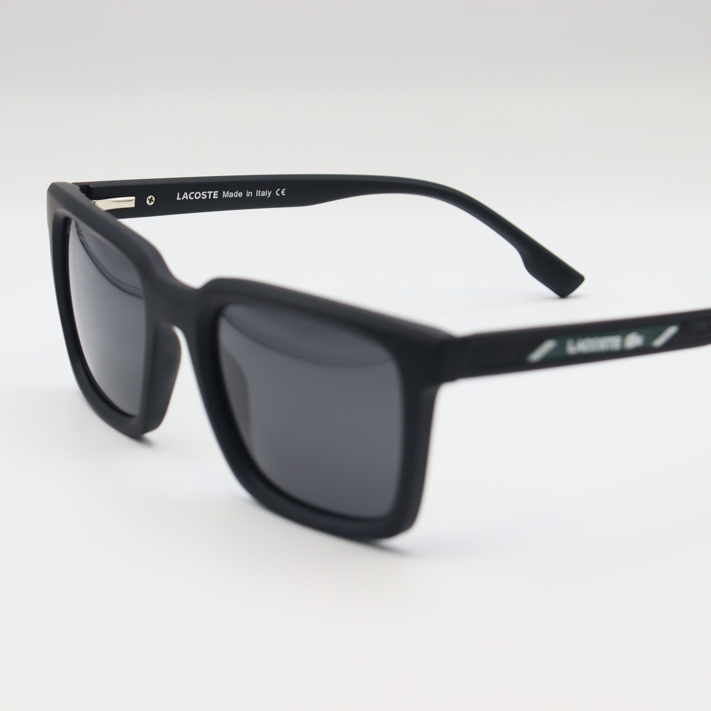 Black Lacoste square sunglasses with lightweight frame and polarized lenses, designed for stylish sun protection.