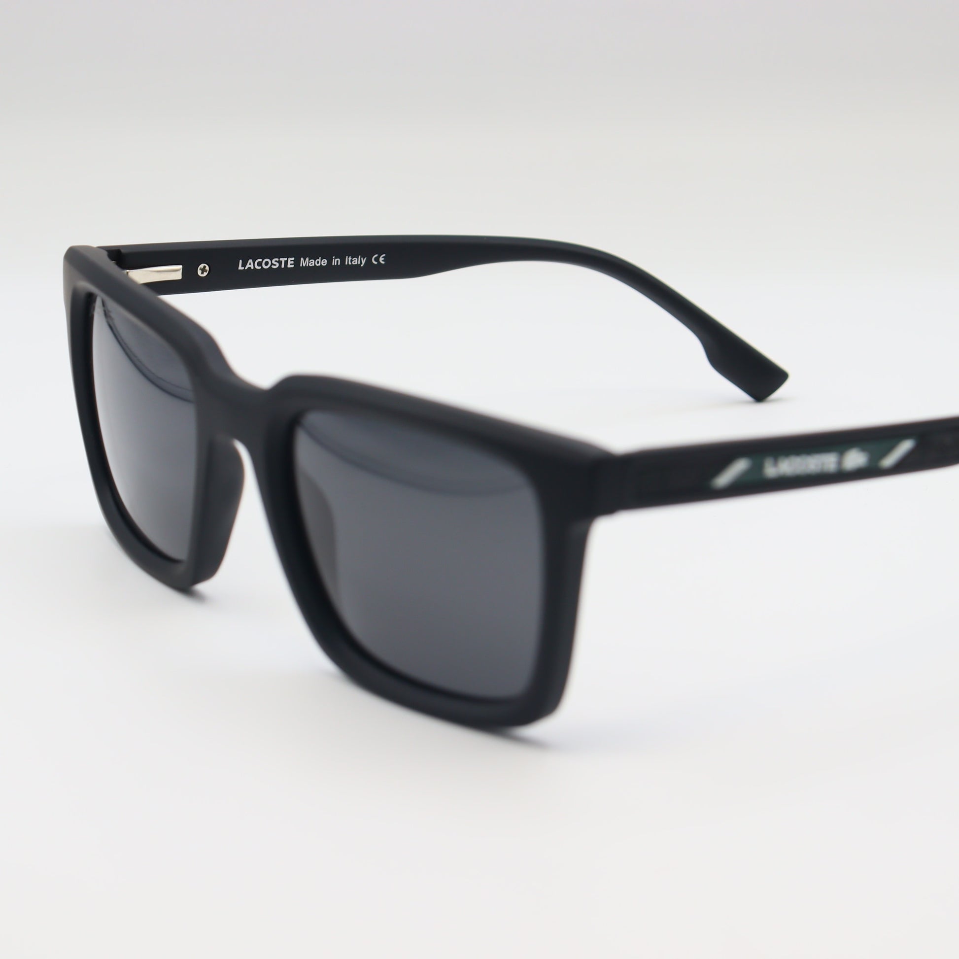 Black Lacoste square sunglasses with lightweight frame and polarized lenses, designed for stylish sun protection.